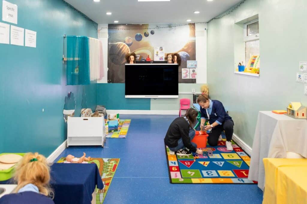 Children playing in the main room at Trinity Playcentre nursery in Dagenham